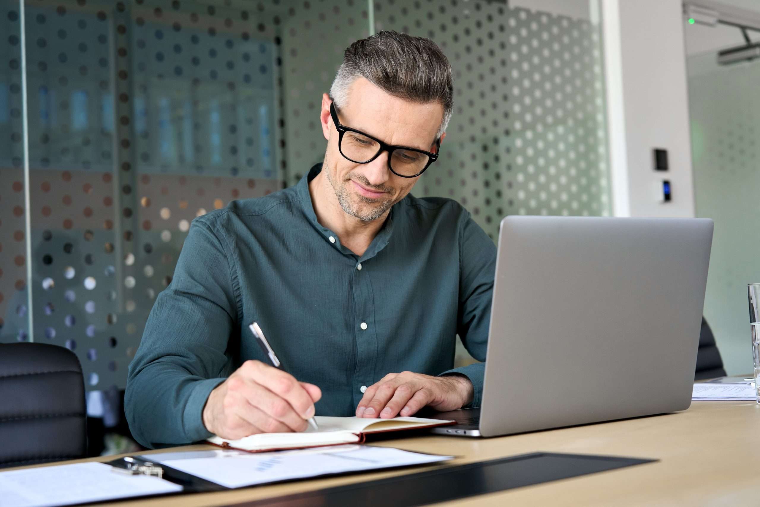 Happy,Mature,Executive,Ceo,Manager,Using,Laptop,Writing,Notes,In